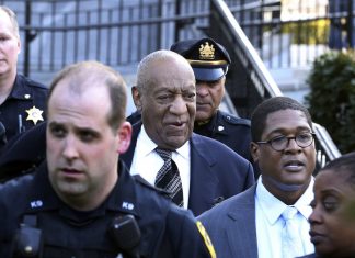 Topless protester with ‘Girls’s Lives Matter’ written on chest expenses at Invoice Cosby as retrial begins