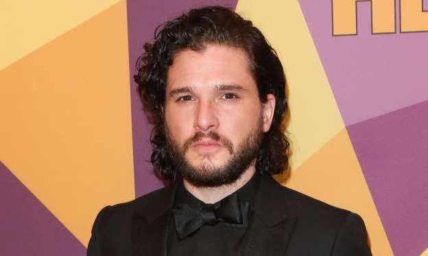 Kit Harington wearing a suit and tie