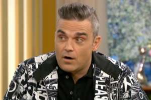Robbie Williams wearing a uniform: Robbie's involvement in the singing contest could lend it a much-needed ratings boost