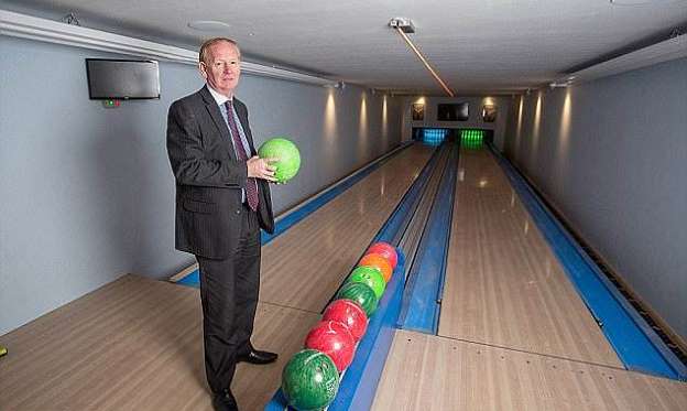 a man standing in a room: Graham Wildin, 66, caused outrage when he built the 10,000sq/ft leisure centre, complete with a bowling alley, at his home in Cinderford, Gloucestershire