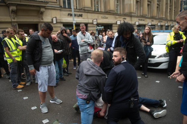 Security guards take down and restrain a street thief after he snatched ??170 from a woman as she used a Tesco Cash machine on Market st in Manchester. Crowds soon formed and arguments broke out as certain members of the public wern't happy with the heavy treatment of the thief as they held him down waiting for the Police to arrive. Disclaimer: While Cavendish Press (Manchester) Ltd uses its' best endeavours to establish the copyright and authenticity of all pictures supplied, it accepts no liability for any damage, loss or legal action caused by the use of images supplied. The publication of images is solely at your discretion. For terms and conditions see http://www.cavendish-press.co.uk/pages/terms-and-conditions.aspx