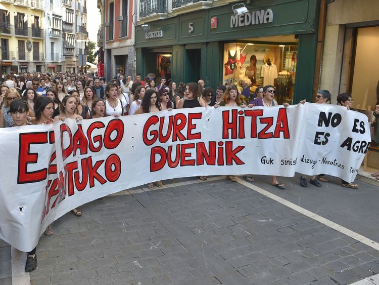 Demonstrators hold a banner reading: &#39;There is no one who judges our word - it is not abuse, it is aggression&#39;