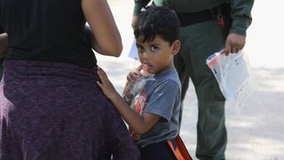 A family waits to be taken into custody