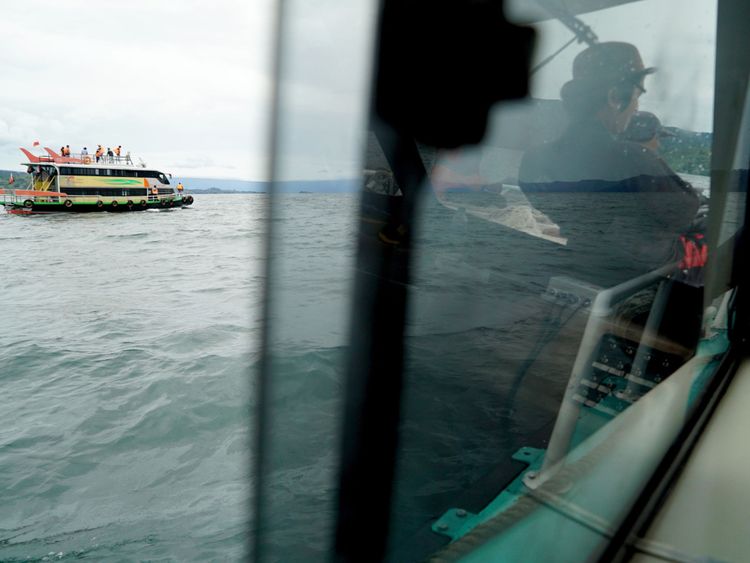 Rescue teams search for victims at the Lake Toba ferry port in the province of North Sumatra 