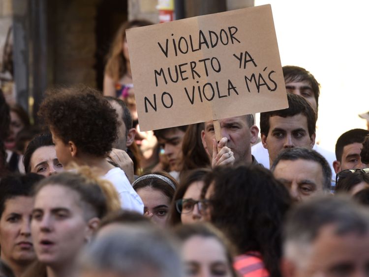 A woman holds a placard that reads: &#39;A dead rapist does not rape anymore&#39; 