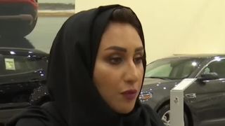 A woman prepares to buy a car in Saudi Arabia