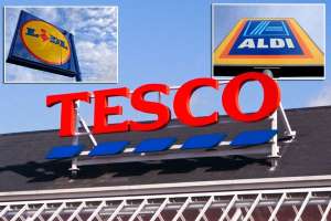 a close up of a sign: All change please - Tesco is on a mission to revamp its shelves