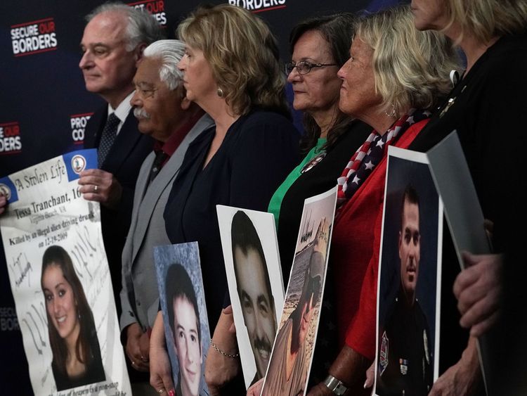 Family members hold portraits of their deceased loved ones that were signed by President Donald Trump during an event with &#39;Angel Families&#39; June 22, 2018